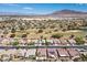 Extensive aerial view of a community adjacent to a golf course with mountain views at 5577 Golden Leaf Ave, Las Vegas, NV 89122