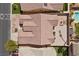 An aerial view showcases a home with a tile roof, a rock backyard and a fire pit, with a pool nearby at 5577 Golden Leaf Ave, Las Vegas, NV 89122