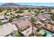 Aerial view of neighborhood, showcasing single-Gathering homes, manicured lawns, mature trees, pools, and a golf course nearby at 5577 Golden Leaf Ave, Las Vegas, NV 89122