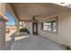 Back patio features a ceiling fan, a large window and a view of the landscaped backyard at 5577 Golden Leaf Ave, Las Vegas, NV 89122