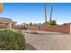 An inviting backyard featuring a rock bed, a small footbridge, and a backdrop of mature trees, perfect for outdoor relaxation at 5577 Golden Leaf Ave, Las Vegas, NV 89122