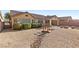 Backyard with rock landscaping, a small bridge over a dry creek bed and a fire pit at 5577 Golden Leaf Ave, Las Vegas, NV 89122