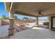 Covered patio with ceiling fan, fire pit, and landscaped backyard at 5577 Golden Leaf Ave, Las Vegas, NV 89122