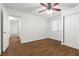 This is a bedroom featuring wood floors, a ceiling fan, window, and double door closet at 5577 Golden Leaf Ave, Las Vegas, NV 89122