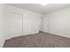 Bedroom featuring neutral carpet, double-door closet, and a door that leads outside of the room at 5577 Golden Leaf Ave, Las Vegas, NV 89122