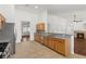 Open kitchen with stainless appliances and breakfast bar overlooking the living room at 5577 Golden Leaf Ave, Las Vegas, NV 89122