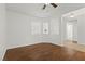Bright living room with hardwood flooring, ceiling fan, and large windows at 5577 Golden Leaf Ave, Las Vegas, NV 89122