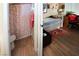 Shared bedroom & bathroom setup showcasing a daybed, desk, and adjacent bathroom with a shower at 6705 Old Newbury Ave, Las Vegas, NV 89108