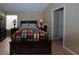 Comfortable bedroom with dark wood furniture, a bright, patterned quilt, and neutral walls at 6705 Old Newbury Ave, Las Vegas, NV 89108