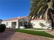 Single story home with a tile roof, desert landscaping, and a mature palm tree at 6705 Old Newbury Ave, Las Vegas, NV 89108