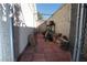Narrow side yard featuring a concrete wall and partially covered area, great for storage at 6705 Old Newbury Ave, Las Vegas, NV 89108