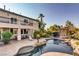 Large backyard featuring a swimming pool, covered patio and green landscaping at 7210 El Malpais St, Las Vegas, NV 89118