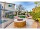 Inviting backyard with a fire pit, beautiful landscaping, and a glimpse of the refreshing pool at 7210 El Malpais St, Las Vegas, NV 89118