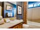Stylish bathroom with a vanity, sink, toilet, shower, and a framed picture, enhanced by dark blue walls at 7210 El Malpais St, Las Vegas, NV 89118