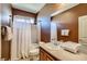 Cozy bathroom featuring a shower-tub combination, vanity with a sink and a decorative mirror at 7210 El Malpais St, Las Vegas, NV 89118