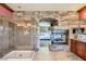 Bathroom featuring large walk-in shower, fireplace and stone accent wall at 7210 El Malpais St, Las Vegas, NV 89118