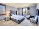Comfortable bedroom features plush carpet, sitting area, natural light, and a tufted headboard at 7210 El Malpais St, Las Vegas, NV 89118