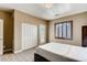 Bedroom with plush carpets, natural light, and a private balcony entrance at 7210 El Malpais St, Las Vegas, NV 89118