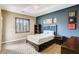 Cozy bedroom with modern decor, natural light, plush carpet, and dark blue accent wall at 7210 El Malpais St, Las Vegas, NV 89118