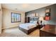 Well decorated bedroom featuring a striking accent wall, stylish furniture and a view of the outside at 7210 El Malpais St, Las Vegas, NV 89118