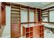 Spacious walk-in closet with custom shelving, drawers, and ample storage space at 7210 El Malpais St, Las Vegas, NV 89118