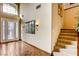 Elegant foyer featuring hardwood floors, high ceilings, decorative lighting, and a staircase at 7210 El Malpais St, Las Vegas, NV 89118