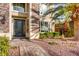 Charming home featuring a decorative front door, stone accents, and landscaped front yard at 7210 El Malpais St, Las Vegas, NV 89118