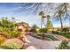 Idyllic backyard featuring a gazebo surrounded by lush landscaping and hardscape at 7210 El Malpais St, Las Vegas, NV 89118