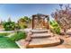 Beautiful gazebo with steps leading up to a seating area, surrounded by green landscaping at 7210 El Malpais St, Las Vegas, NV 89118