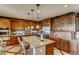 Gourmet kitchen features custom cabinets, granite countertops, and stainless steel appliances at 7210 El Malpais St, Las Vegas, NV 89118
