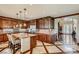 Spacious kitchen with custom cabinets, granite countertops, an island, and modern stainless steel appliances at 7210 El Malpais St, Las Vegas, NV 89118