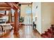 Expansive living room with fireplace, high ceilings, hardwood floors, and pool table visible from the foyer at 7210 El Malpais St, Las Vegas, NV 89118