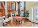 Inviting living room features a stone fireplace, pool table, and hardwood floors at 7210 El Malpais St, Las Vegas, NV 89118