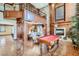 Elegant open-concept living room boasts a fireplace, pool table, and dining area at 7210 El Malpais St, Las Vegas, NV 89118
