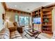Inviting living room with built-in shelves, comfortable seating and a sliding glass door to the outside at 7210 El Malpais St, Las Vegas, NV 89118