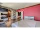 Charming main bedroom featuring fireplace, hardwood floors, ensuite bath, and bright accent wall at 7210 El Malpais St, Las Vegas, NV 89118
