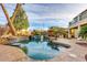 Beautiful backyard pool and waterfall, complemented by lush landscaping and a covered patio area at 7210 El Malpais St, Las Vegas, NV 89118