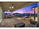Spacious back patio with ceiling fans opens to an outdoor living area with a pool and landscaped backyard at 7277 W Landberg Ave, Las Vegas, NV 89178
