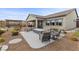 Large backyard with a covered patio, fire pit, and outdoor kitchen area at 7277 W Landberg Ave, Las Vegas, NV 89178