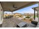 Spacious backyard featuring a covered patio, outdoor seating, swimming pool, and lush landscaping at 7277 W Landberg Ave, Las Vegas, NV 89178