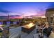 Backyard featuring a fire pit, outdoor kitchen, pool, and lounging area, ideal for outdoor entertaining at 7277 W Landberg Ave, Las Vegas, NV 89178