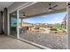 A beautiful backyard with an outdoor patio and dining area, along with a play area and pool beyond at 7277 W Landberg Ave, Las Vegas, NV 89178
