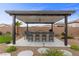 Outdoor barbecue area with bar seating and well-maintained landscaping at 7277 W Landberg Ave, Las Vegas, NV 89178