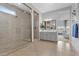 Bathroom featuring a modern, glass-enclosed shower, dual sinks, and a view into the bedroom at 7277 W Landberg Ave, Las Vegas, NV 89178