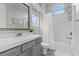 Bathroom showcasing a vanity with modern fixtures, a soaking tub, and bright lighting at 7277 W Landberg Ave, Las Vegas, NV 89178