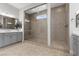 Bathroom showcasing a large glass-enclosed shower with tiled walls, dual sinks, and ample countertop space at 7277 W Landberg Ave, Las Vegas, NV 89178