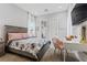 Well-lit bedroom with a decorative bed frame, desk, and neutral walls creating a cozy atmosphere at 7277 W Landberg Ave, Las Vegas, NV 89178