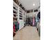 A walk-in closet with custom shelving, ample storage for shoes, and hanging space for clothes at 7277 W Landberg Ave, Las Vegas, NV 89178