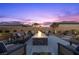 Inviting outdoor fire pit with comfortable seating, perfect for enjoying evenings in a serene backyard setting at 7277 W Landberg Ave, Las Vegas, NV 89178