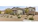 Front yard with well maintained desert landscaping surrounding the home at 7277 W Landberg Ave, Las Vegas, NV 89178